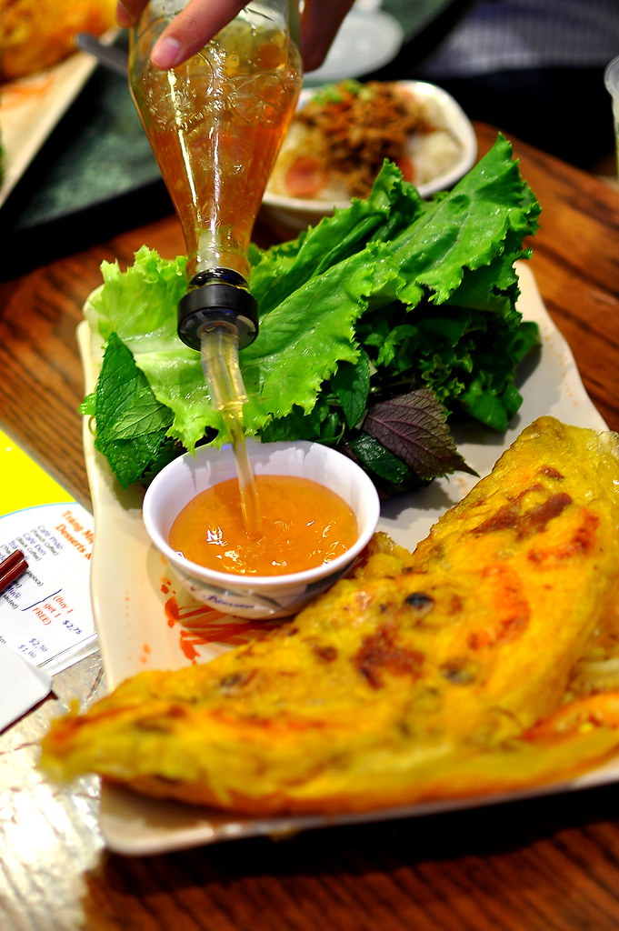 Crispy bánh xèo crepe with fresh herbs and fish sauce